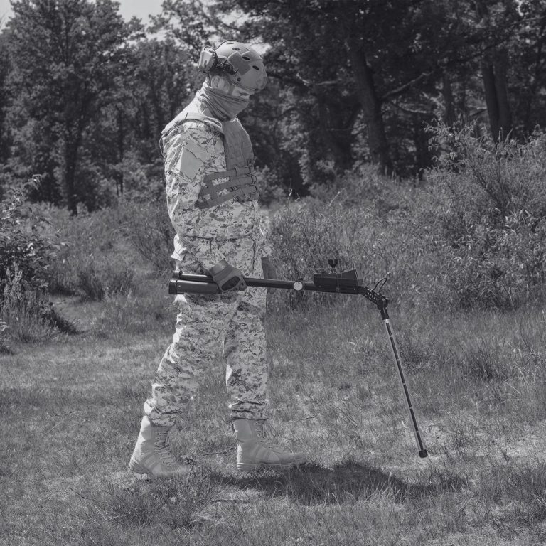 Operator using an Ebinger handheld detector during a battle area clearance survey.