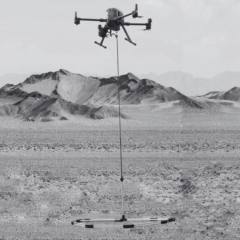 UAV carrying an Ebinger VEMOS AIR pulse-induction sensor for airborne UXO and subsurface metal detection.